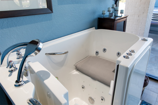 walk-in-tub-home-1-e1561673877761 A white bathtub with a seat in it.